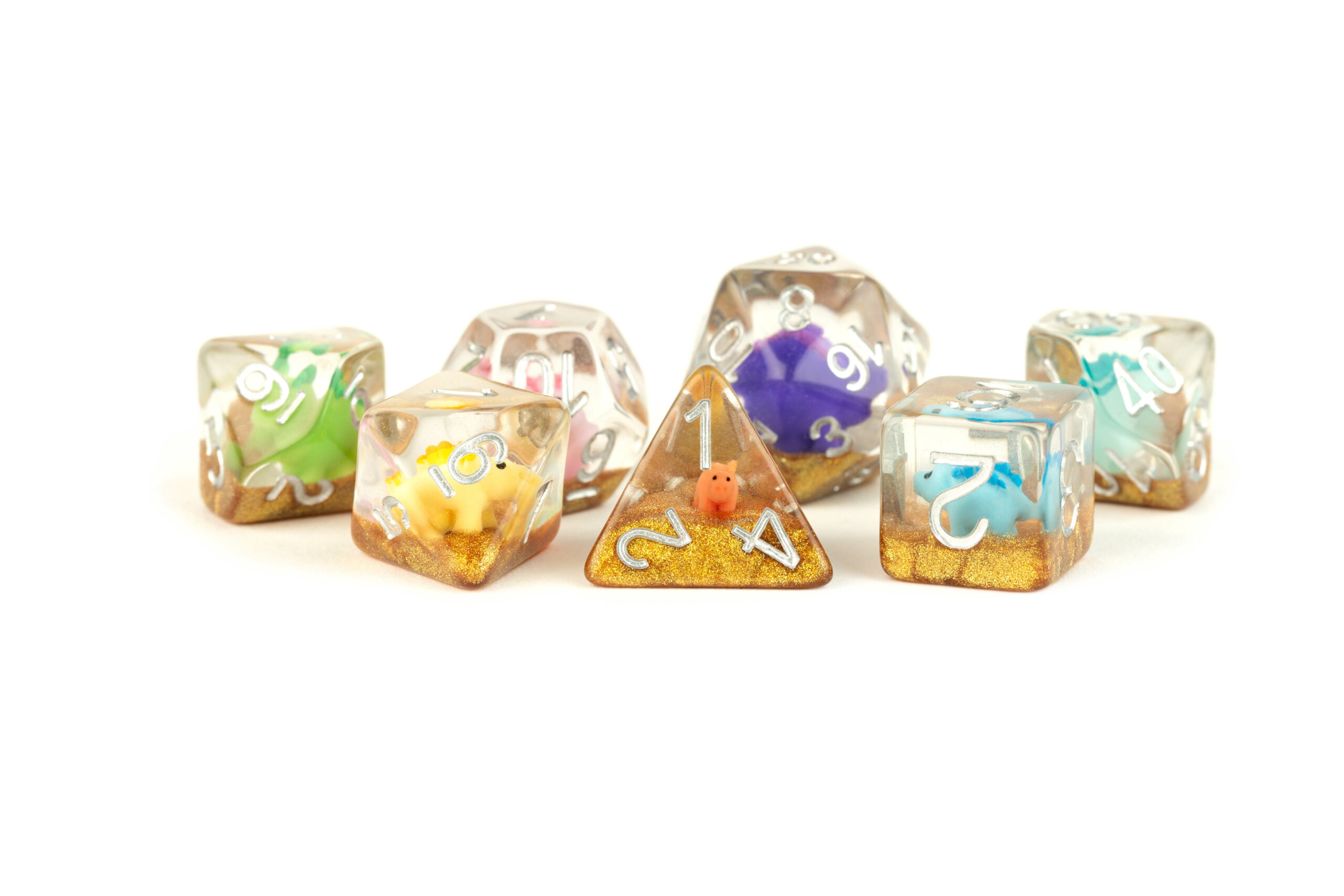 16mm Resin Poly Dice Set that has Rainbow Dinosaur figures with gold sand at the bottom and silver lettering