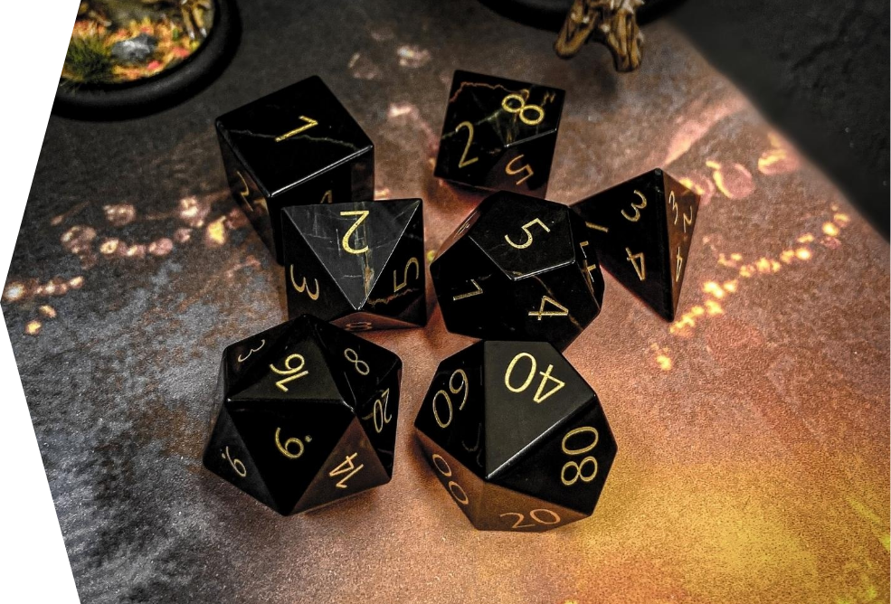 black and gold dice set placed on table